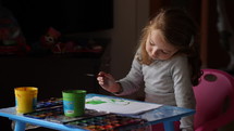 child painting with paints 