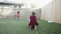 siblings playing in the backyard 