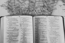 open Bible on a map of Africa, missions preparation