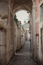 narrow street and hotel sign in Italy 