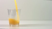 pouring orange juice into a glass 