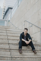 man sitting on concrete steps 
