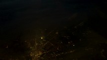 aerial view over suburbs and city at night 