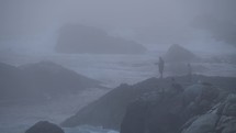 Silhouette of Man Fishing on Misty Coastline of Carmel By The Sea and Big Sur - a Rugged Stretch of California Central Coast known for Winding Roads and Seaside Cliffs