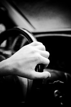 hand on a steering wheel