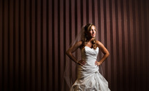 Bride poising in front of striped wall