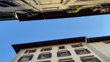 looking up at the sky between buildings in Florence, Italy 
