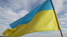 Flag of Ukraine Waving in the Blue Sky