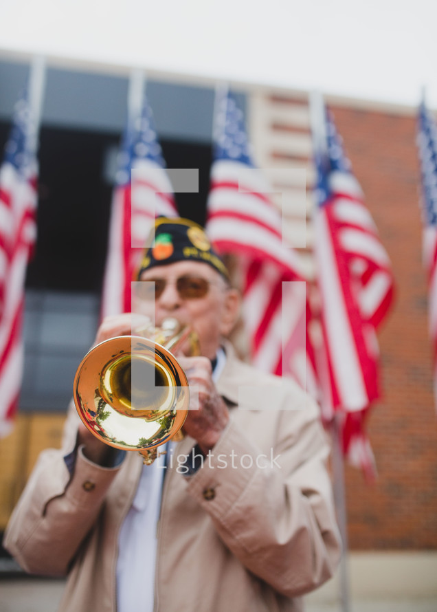 Veteran playing a trumpet to honor fallen soldiers 