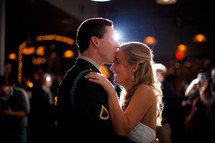 military groom kissing his bride on the forehead