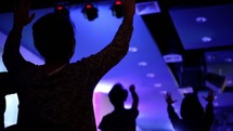 hands raised and song during a worship service 