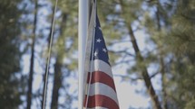 lowering an American flag on a flagpole 