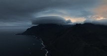 Aerial coastal view of Iceland, dramatic mountains and clouds in the background