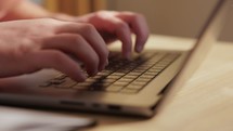 Close Up Of Hands Typing On Laptop Computer	