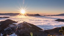 Colorful Sunset in winter mountain landscape time-lapse with low clouds in foggy forest peaceful natural scenery
