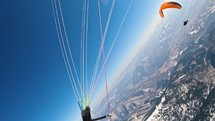 Paragliding over winter mountains.