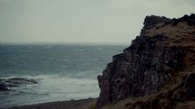 jagged cliffs along a shore 
