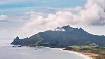 Clouds accumulate over mountain summit in Ocean Beach Coast in New Zealand nature landscape Time lapse
