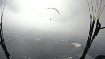 Paraglider fly in misty clouds in to the sun sky. Dream flight paragliding extreme sport adrenaline adventure
