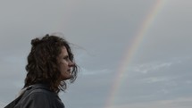 a woman watching a rainbow 
