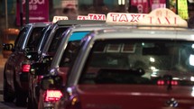 Timelapse of taxi cars waiting for clients in night Hong Kong