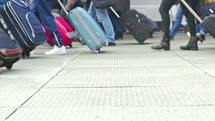people walking with luggage in an airport 