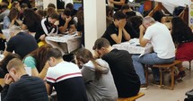 Group of young adults praying together