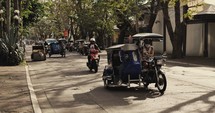Motorcycle, rickshaw, and car traffic in the Philippines