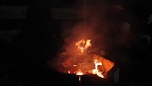 Close up of a campfire burning at night.