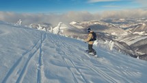 Snowboard freeride in frozen winter mountains in beautiful sunny day, Slow motion of snowboarder in backcountry
