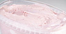 Close up slow motion of scooping of strawberry ice cream
