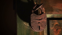 Old wooden door with chain key lock.