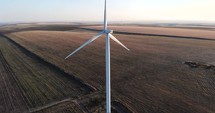 Drone Shot of Wind Turbine Generating Sustainable Energy At a Farm.