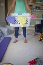 a woman holding a laundry basket 