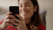 Close up of caucasian woman chatting on the mobile phone and laughing. Indoor. Copy Space

