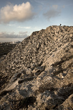 A man hiking on a rocky mountain