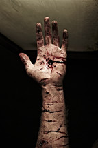 The wounded and nail-scarred hand of Jesus