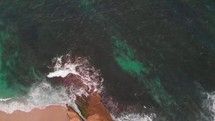aerial view over ocean water and waves 