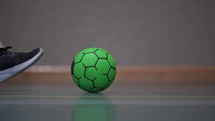 Man kicking green soccer ball