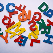 multicolored wooden letters on the white background
