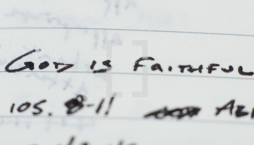 "God is faithful" written in ink on notebook paper.