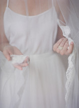 a bride touching her veil 
