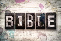 word Bible on white washed wood