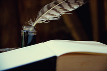 quill pen and ink with open Book 