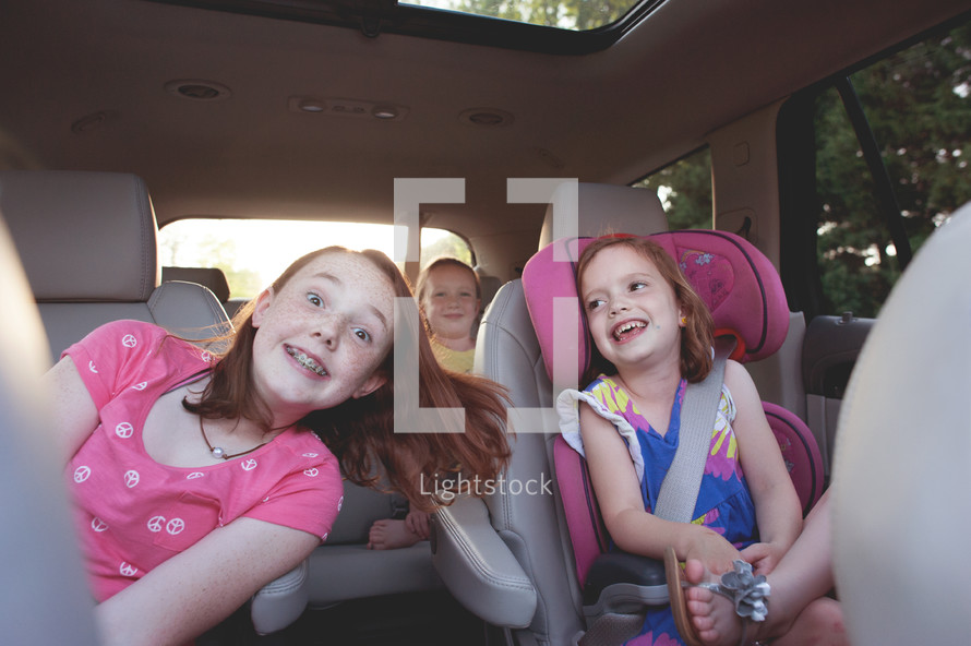 children riding in the backseat 