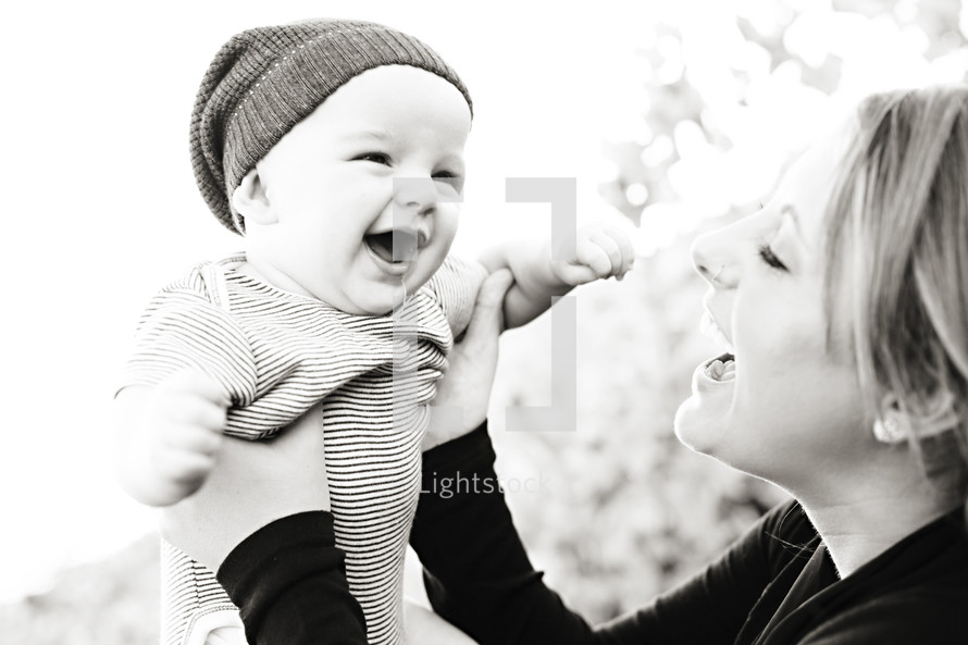 mother holding her happy smiling infant son joy parent mom