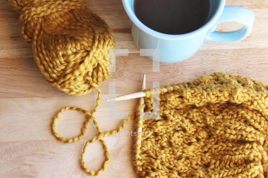 knitting with yarn and a coffee mug 