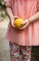 girl holding a lemon 