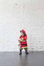 toddler in a fireman costume 