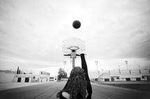 Girl shooting basketball into hoop
